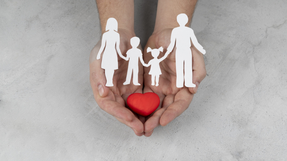 hands-holding-paper-people-heart-close-up